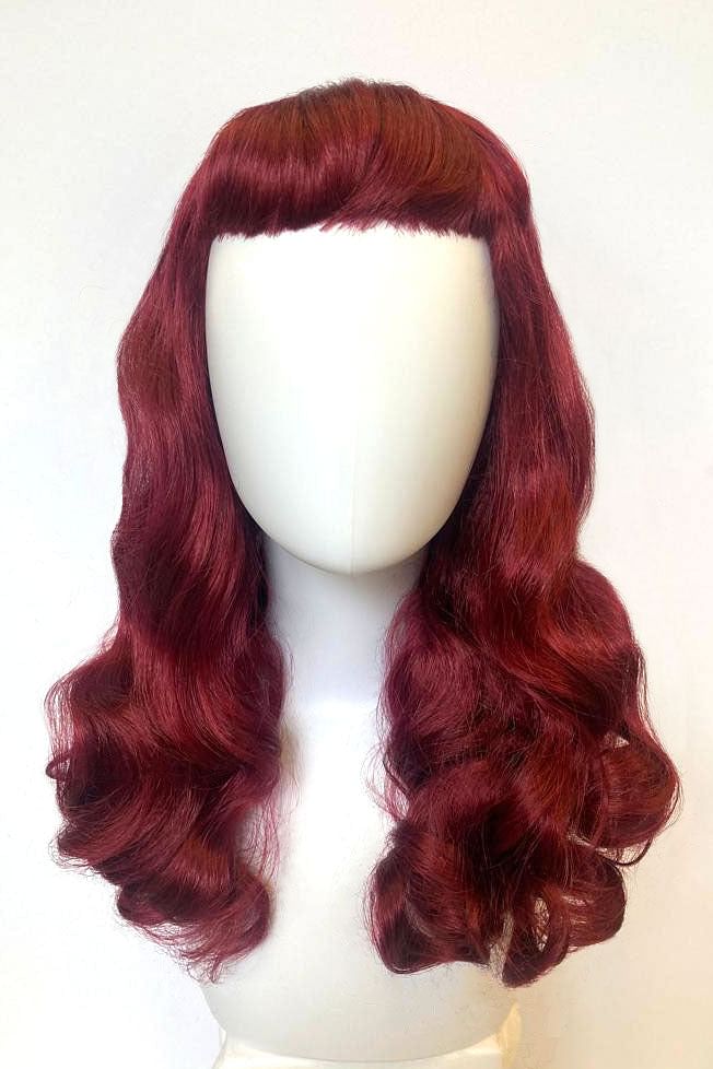 Long cherry red pin-up style wig, gently wavy with short fringe: Maeve AnnabellesWigsLong cherry red pin-up wig, gently wavy with short fringe: Maeve
